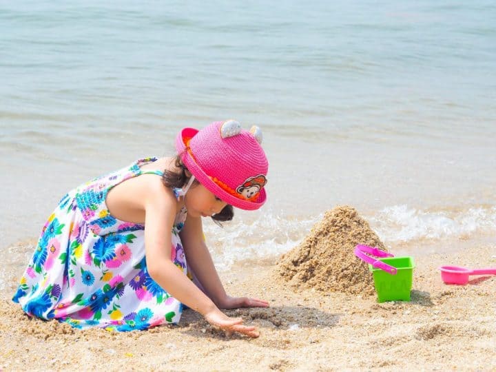 Girl Playing On The Beach