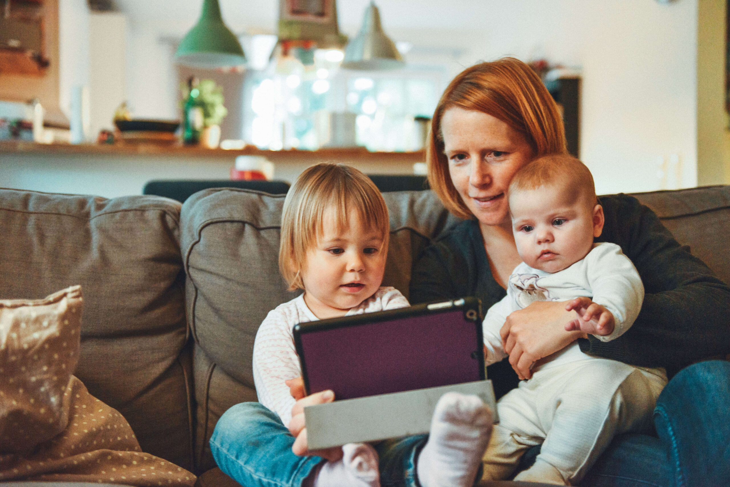 mother and children watching from an electronic gadget
