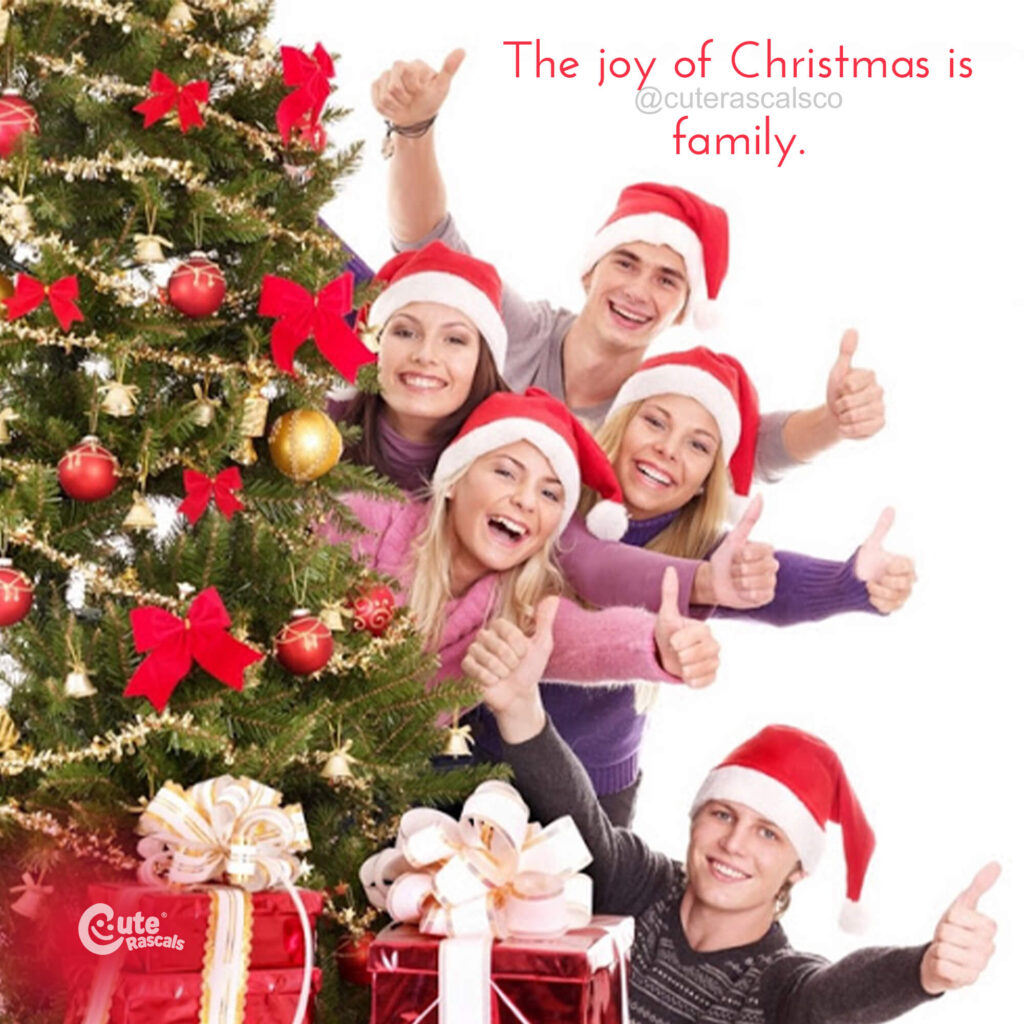 Joyful family behind a Christmas tree with a joyful Christmas message
