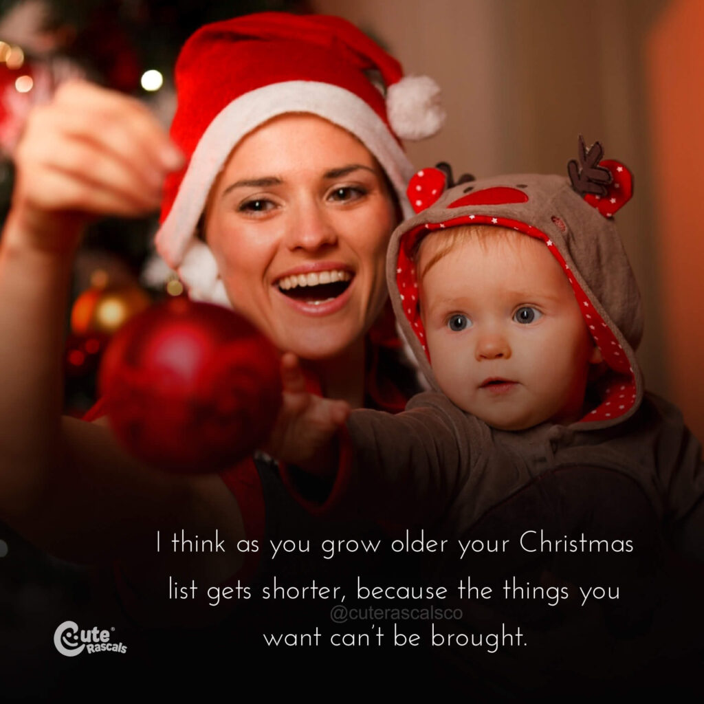 Mommy with baby holding a Christmas ornament. Good Merry Christmas quotes.