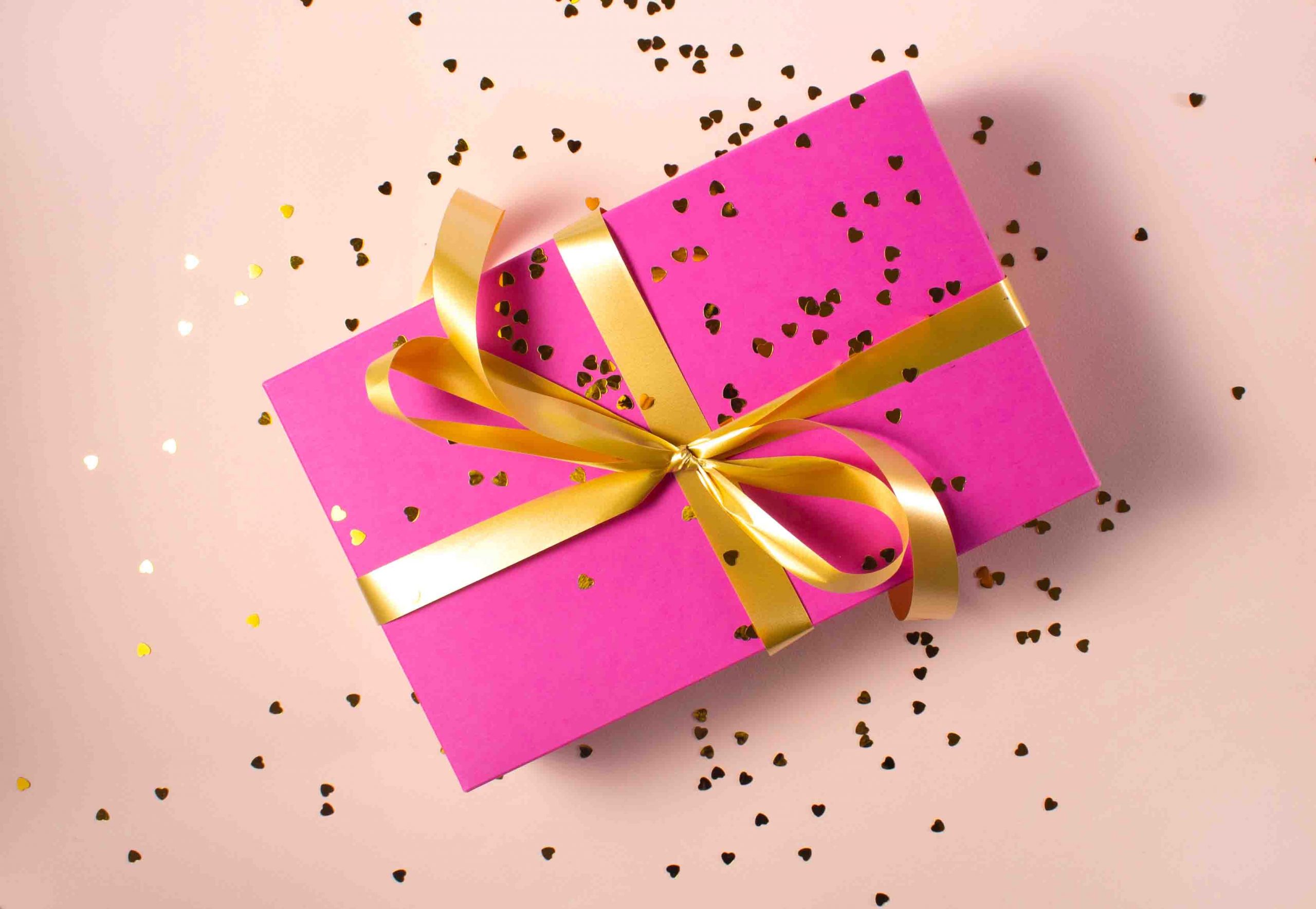 pink gift box with gold ribbon