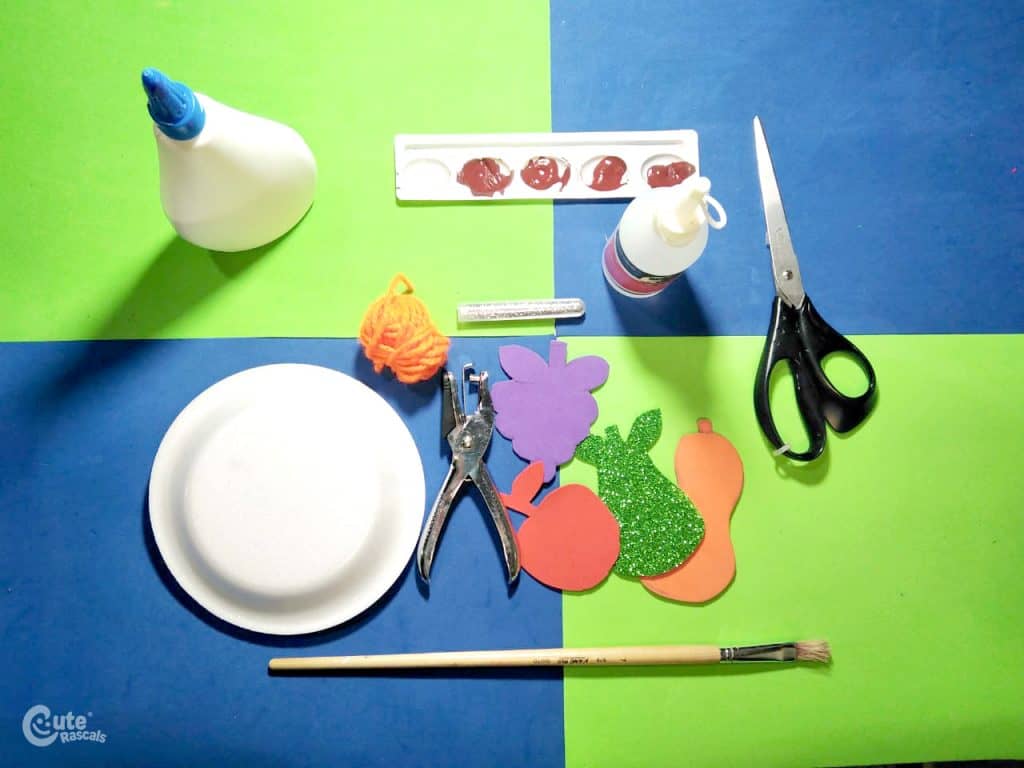 Materials for cornucopia craft, a Thanksgiving paper plate craft for kids.