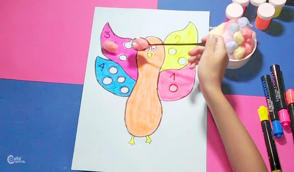 Teach kids about umber and quantity using this fun Thanksgiving turkey cotton wings kids activity.
