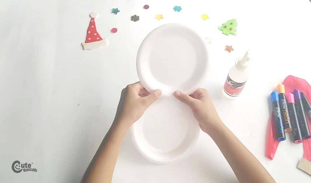 Step one of snowman paper plate craft