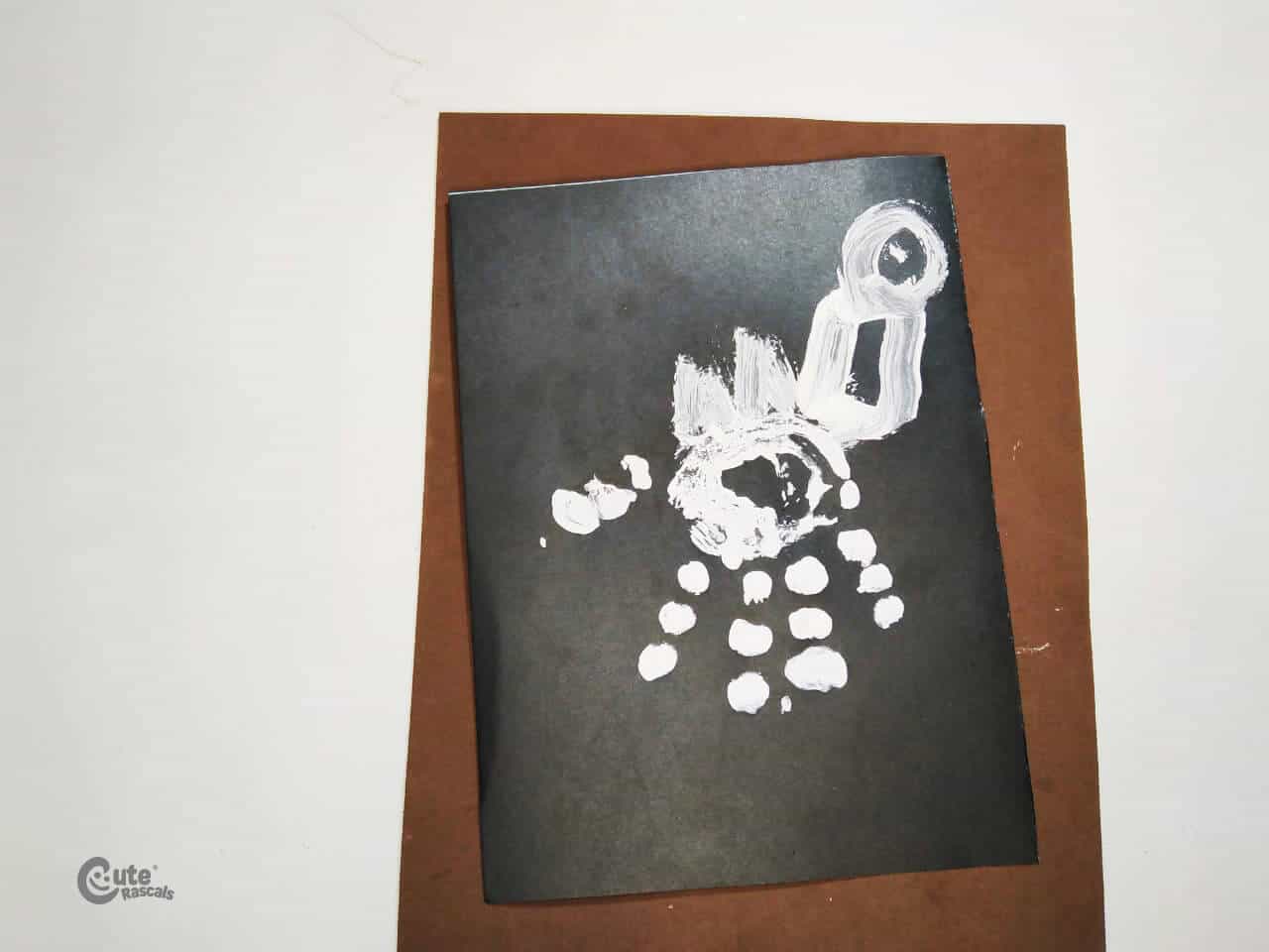 Dinosaur handprint craft made with handprints