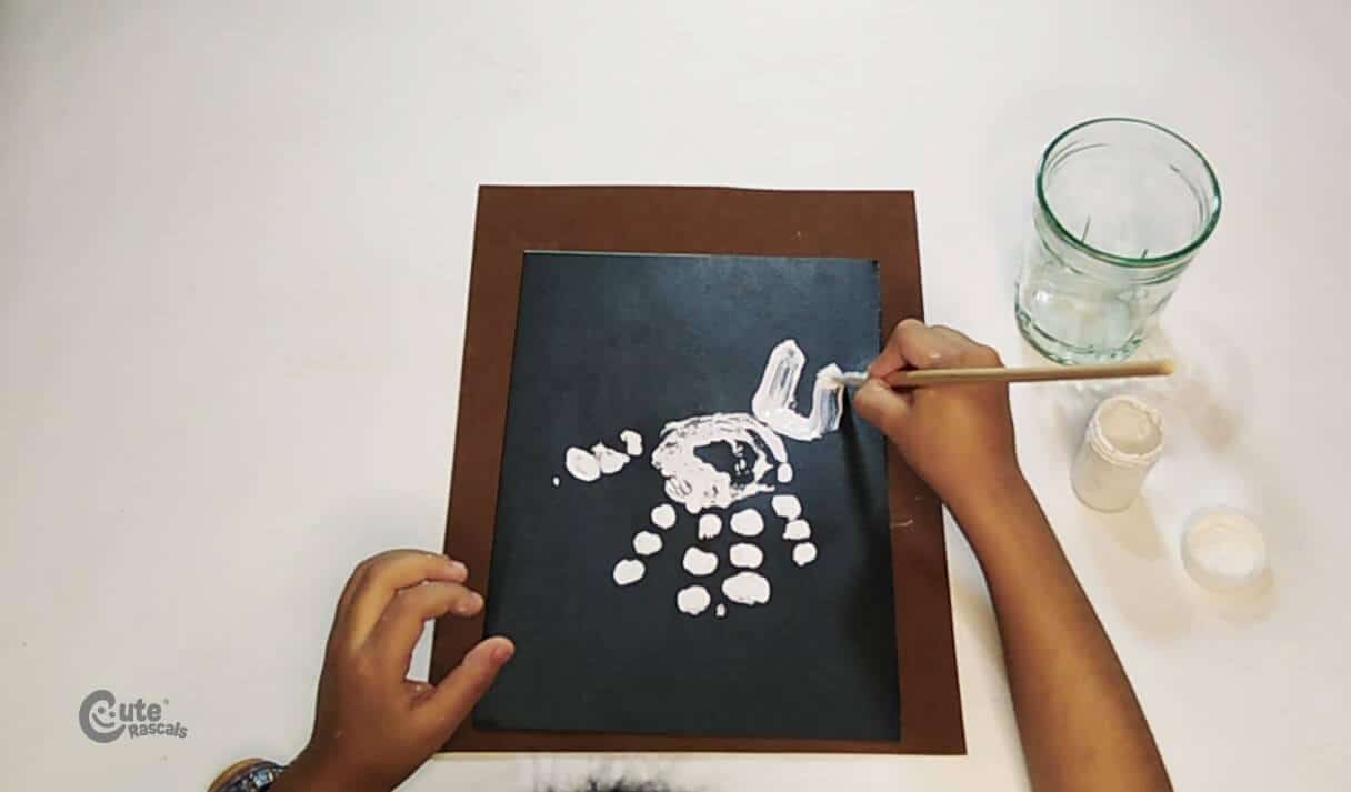 Draw the neck and head of the dinosaur handprint craft