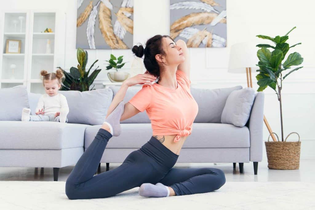 mom doing yoga in living room