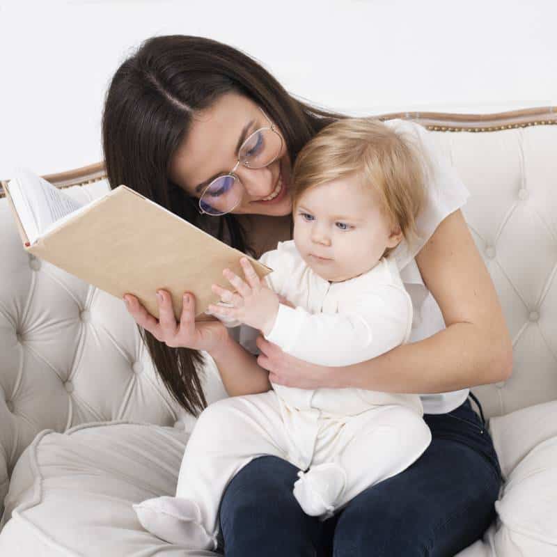 mother-holding-book-baby