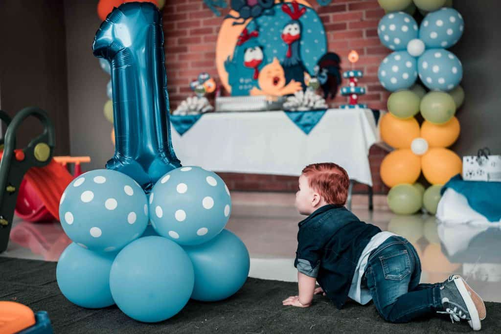 one year old boy with blue balloons 