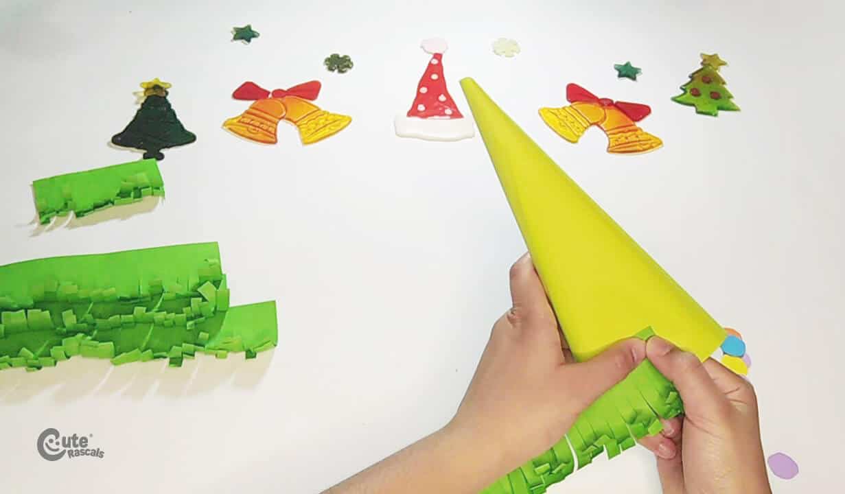 Glue all the strips on the cone paper Christmas tree craft
