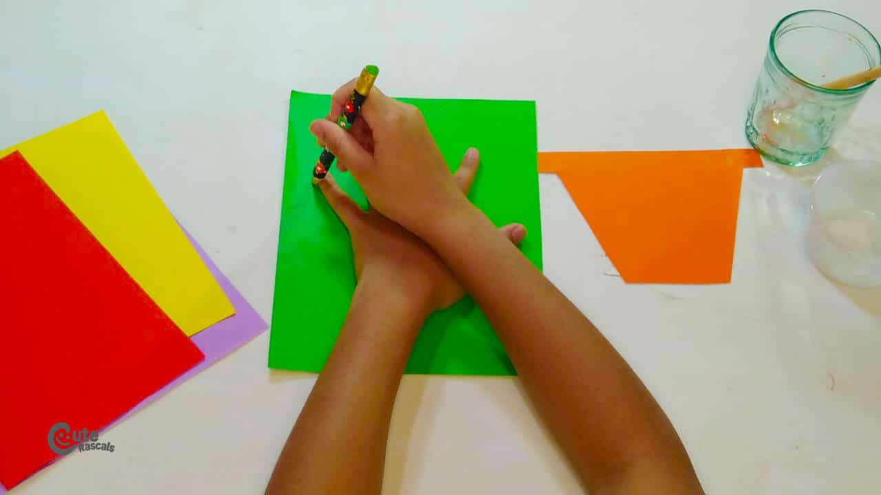 Outline  child's hand on the green paper. spring crafts for kids