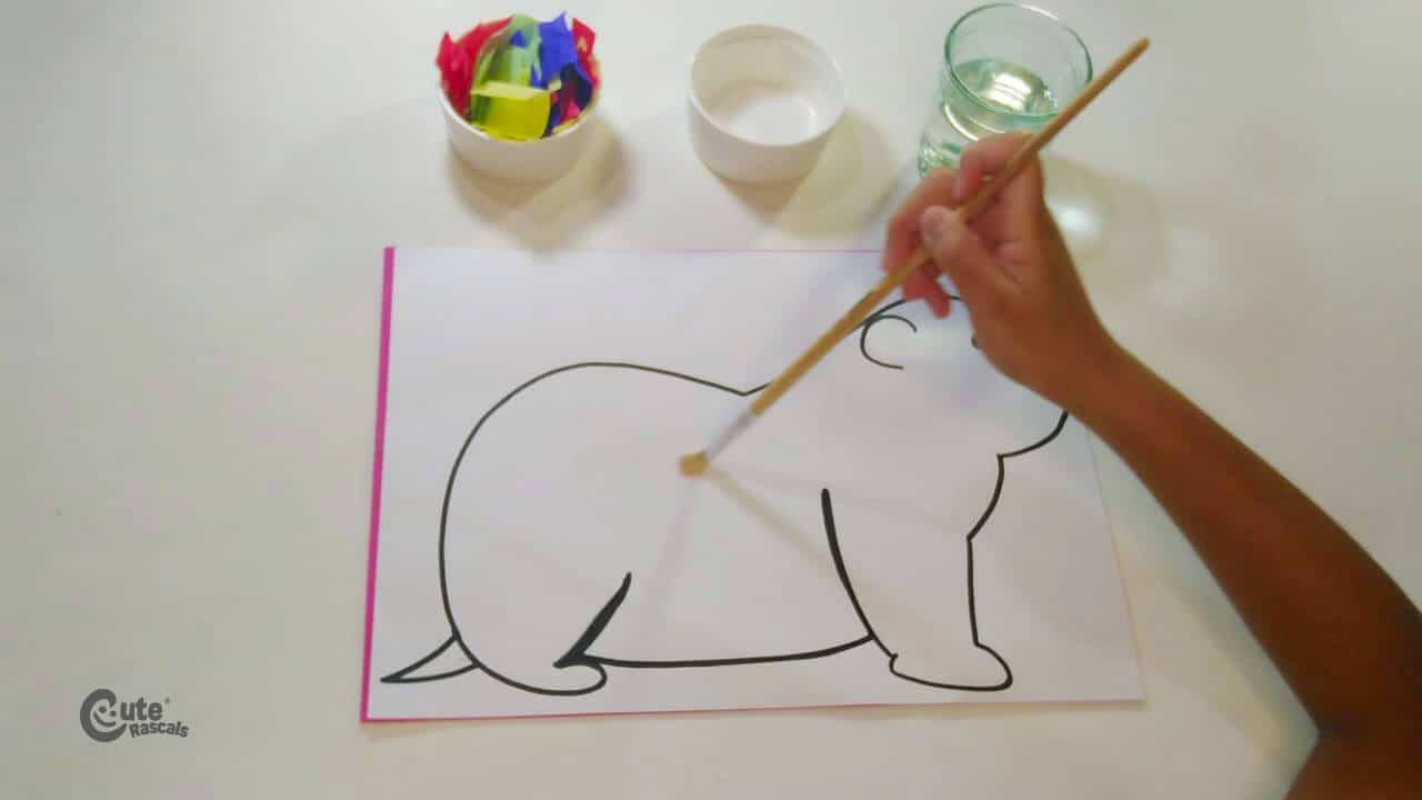 Use the paintbrush to spread water over the groundhog drawing