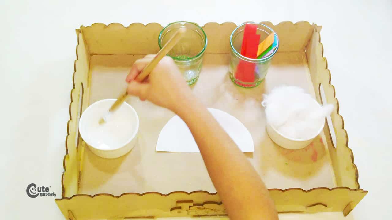 paste the paper strips on the semicircle making a rainbow