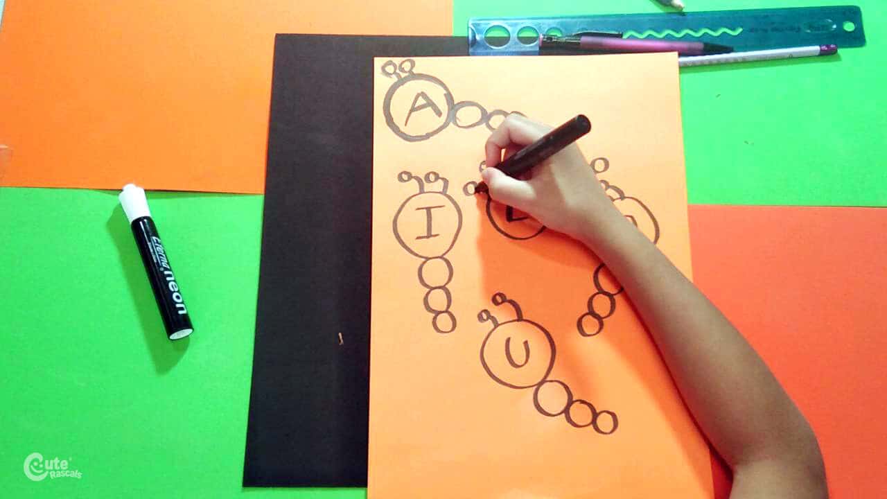 Write vowels in the circles. Fun preschool writing