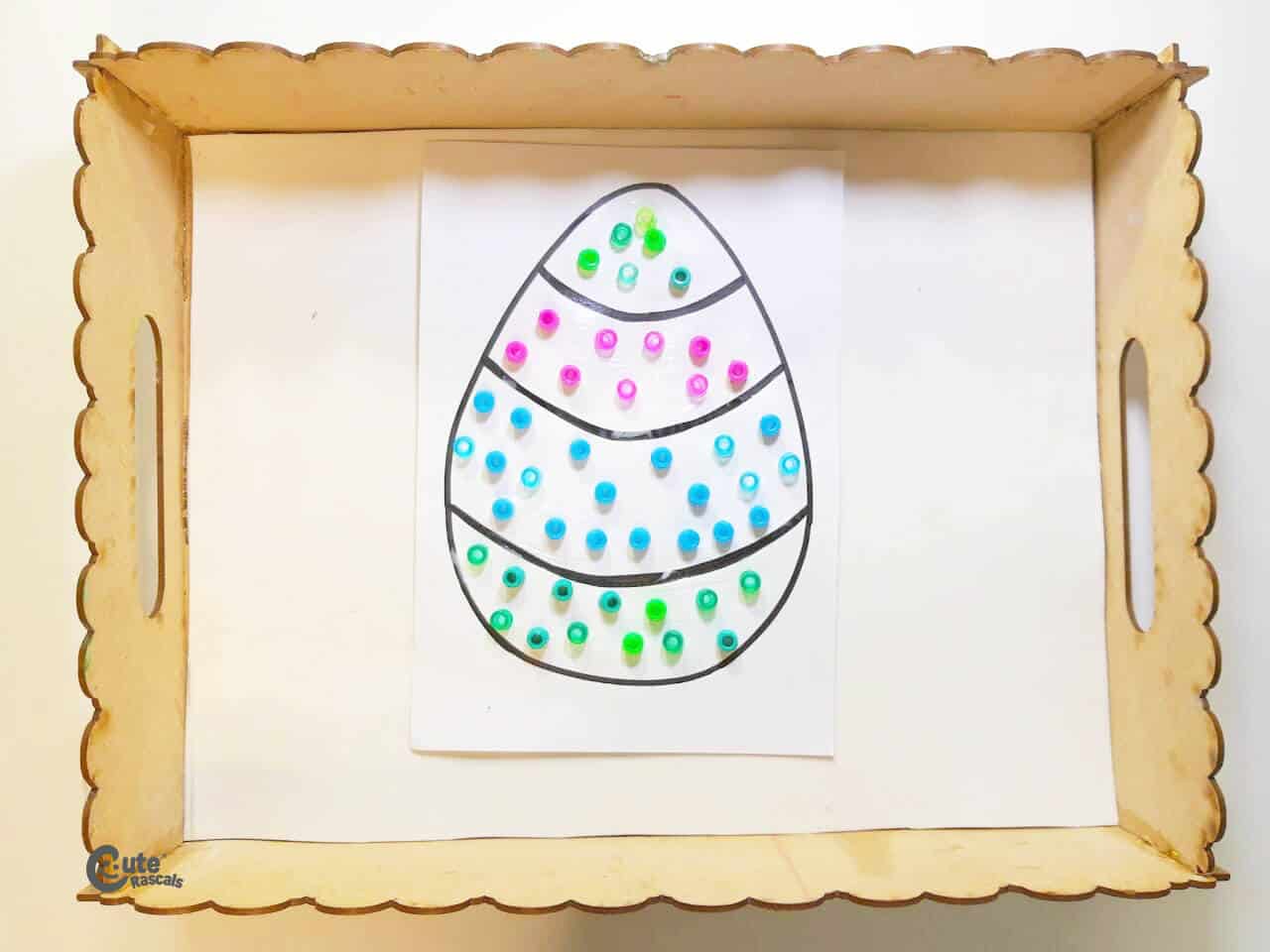 Decorating an Easter egg using motor skills. Fun Easter activity for preschoolers