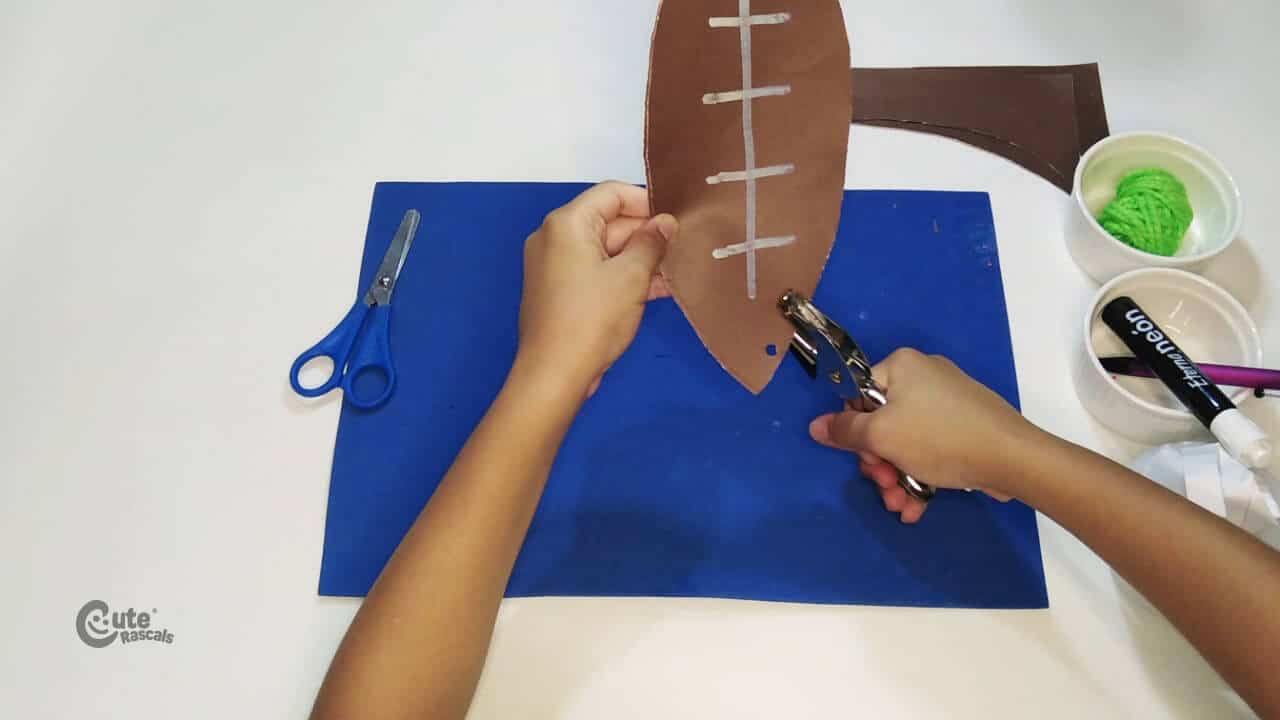 open some holes around the ball edges. football crafts for preschoolers