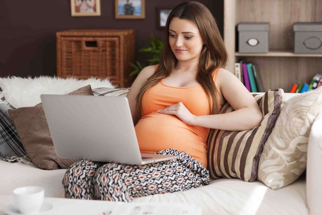 pregnant woman using laptop