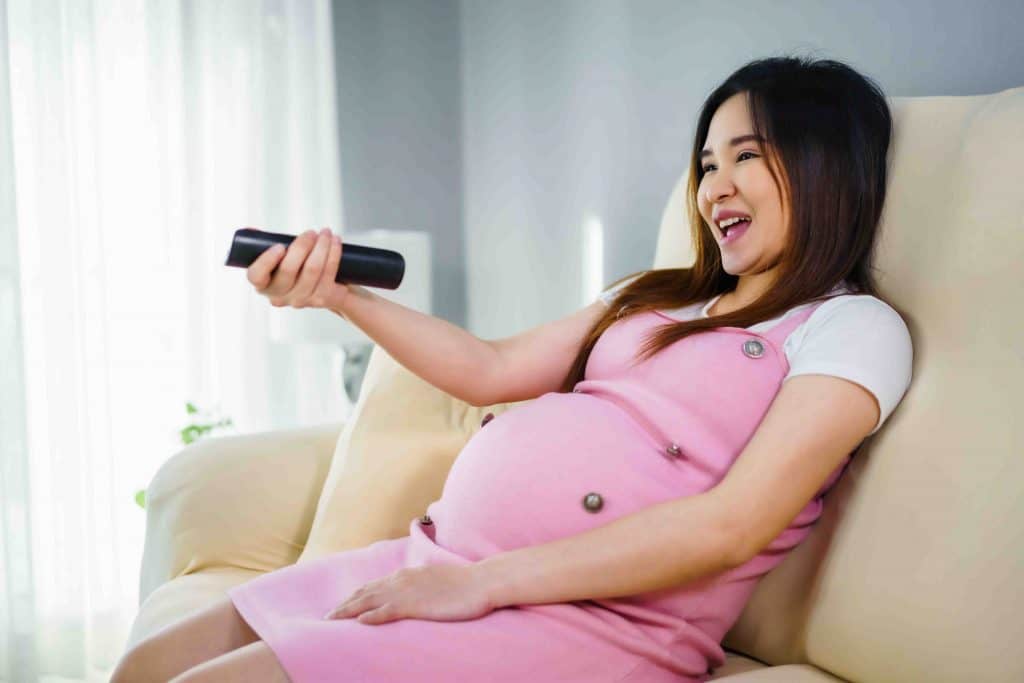 pregnant woman watching TV