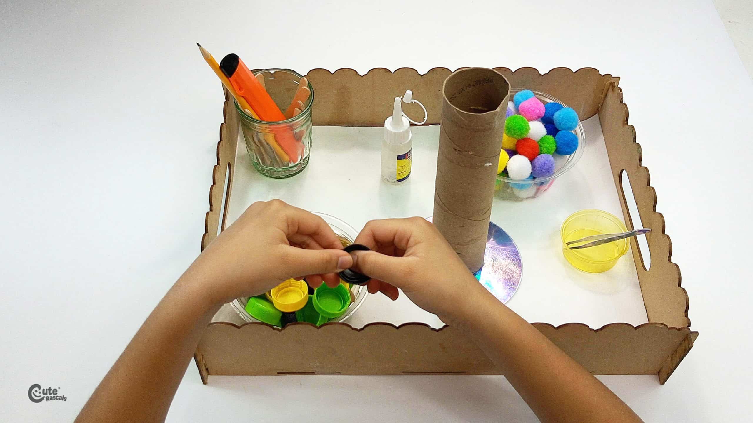 Paste the soda caps on the wooden stick