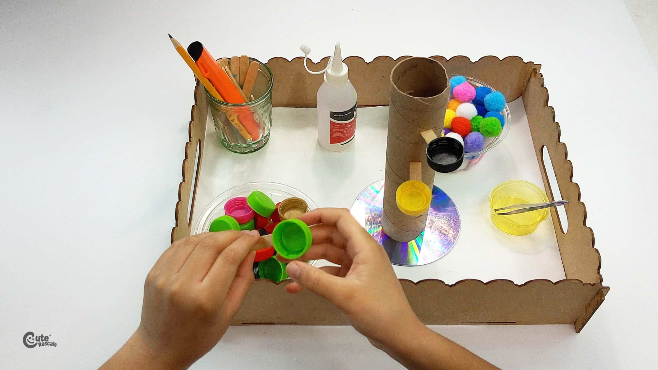 Pass the wooden sticks through the holes. Earth Day activities for kids