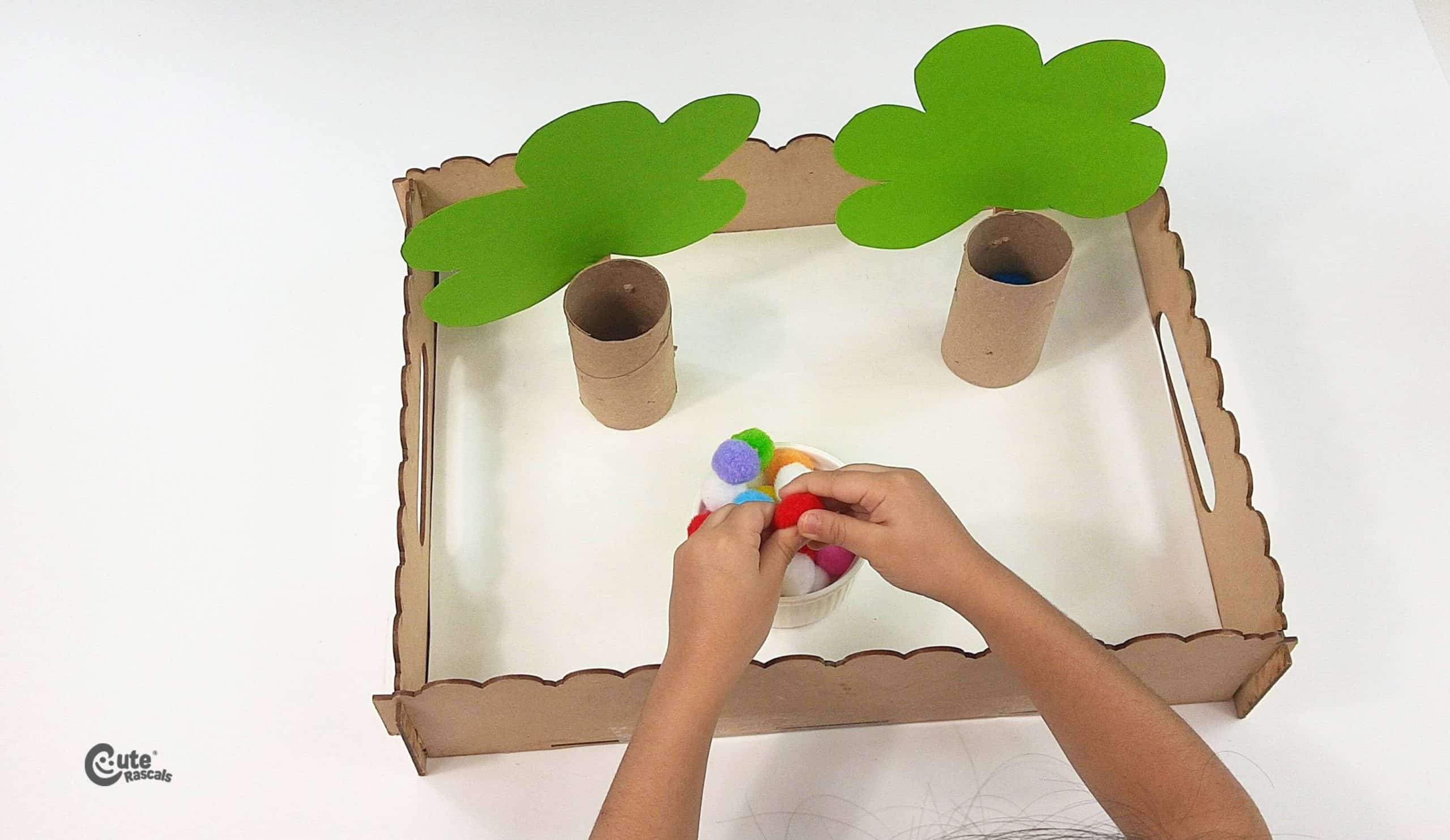 Take the pom-poms from the container. Earth Day projects for kids